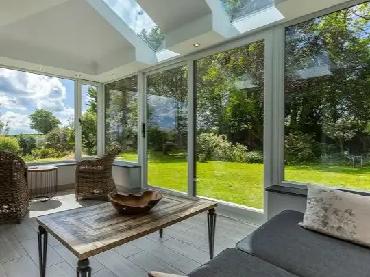 Finished modern aluminum conservatory installed in a residential backyard
