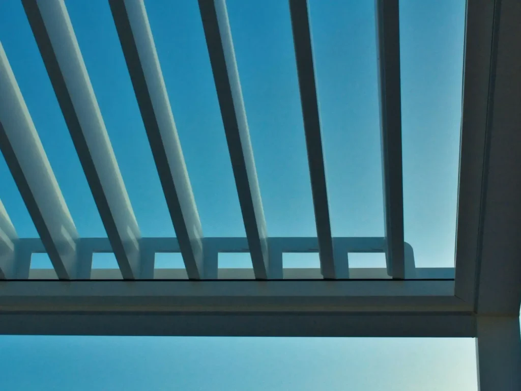 Motorized louvered pergola system for year-round outdoor comfort