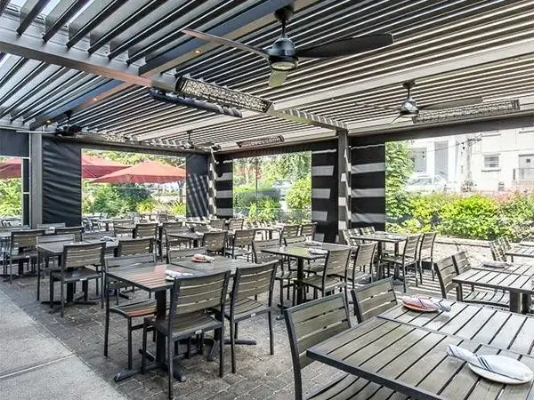 Motorized louvered pergola creating a comfortable outdoor dining and entertaining area