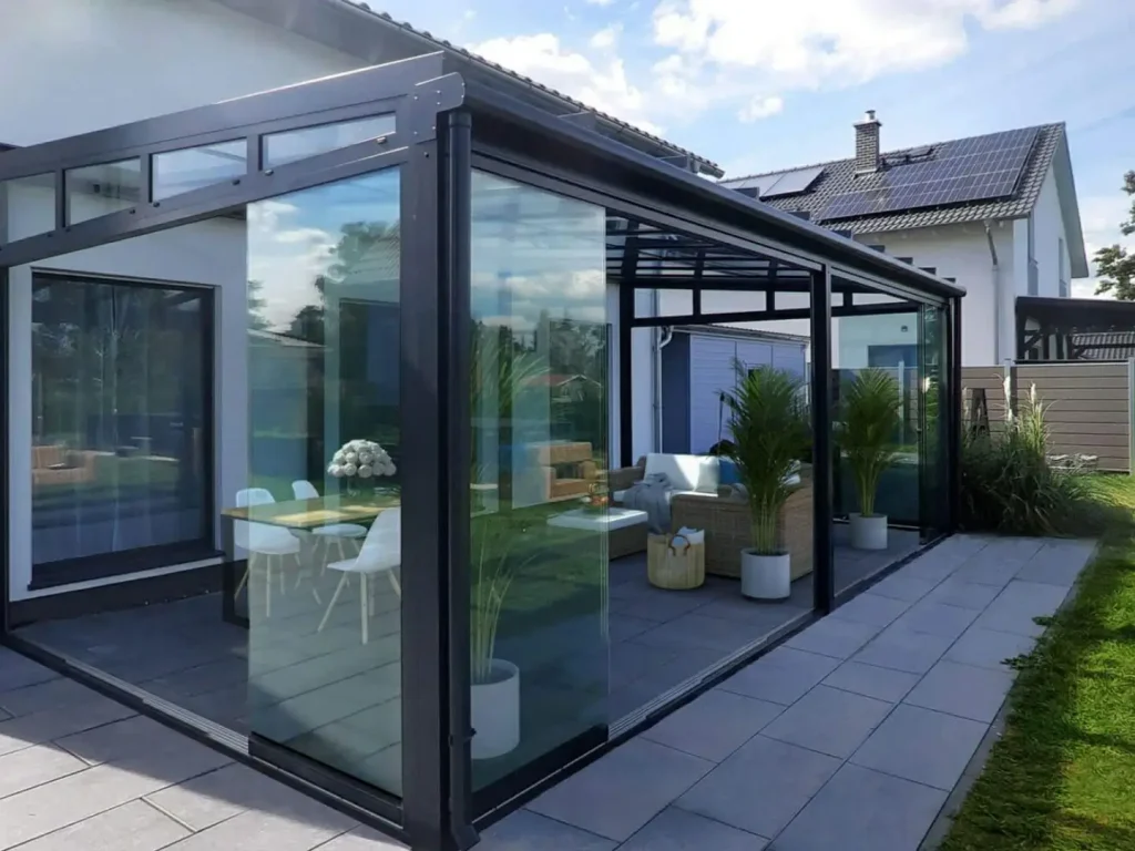 Glass sunroom patio enclosure with aluminium framing and panoramic views
