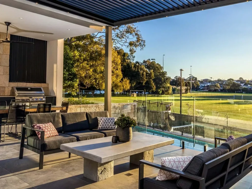 Motorized louvered pergola providing adjustable shade and weather protection