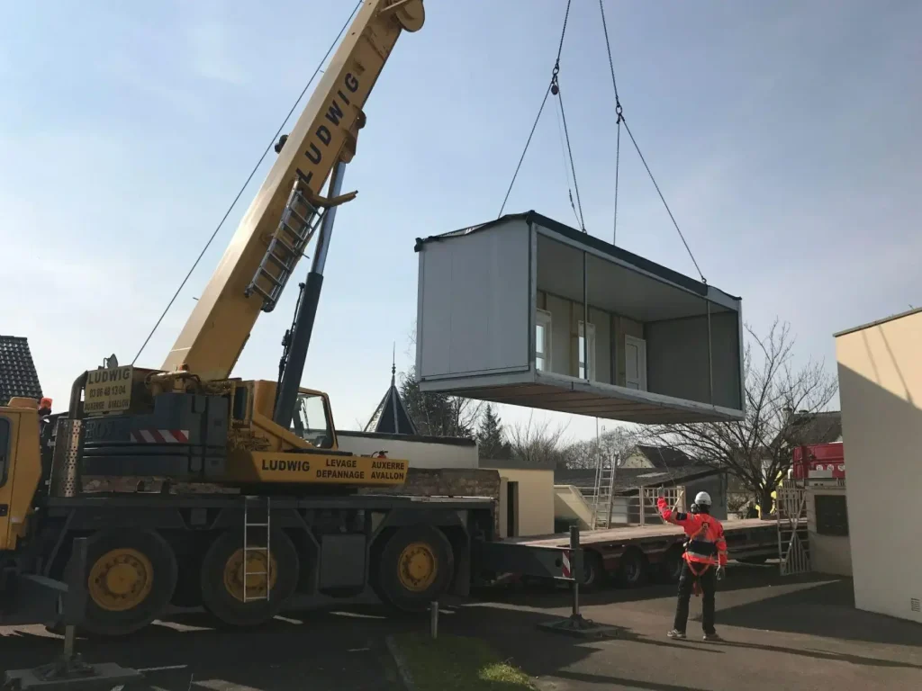 Prefabricated outdoor office pod being delivered and installed on site